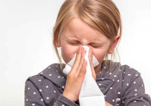 6,Year,Old,Girl,Sneezing,Into,A,White,Tissue,Isolated